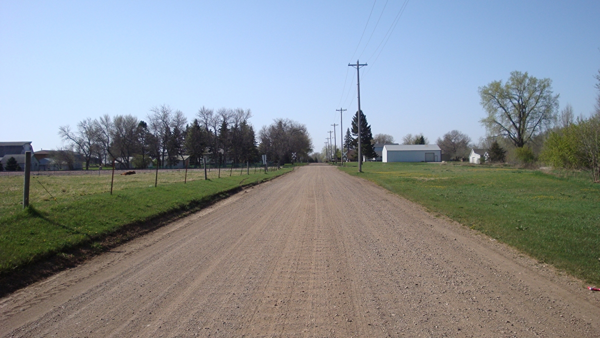 A gravel road stretches into the distance.
