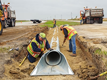 Workers installing a culvert