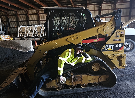 Hunter Mcdougall lays on a CAT track loader