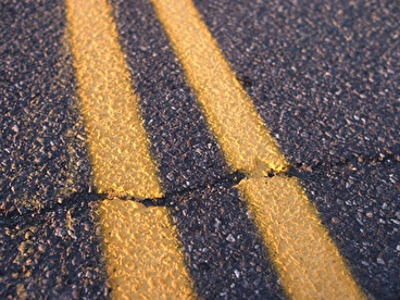 Close up view of cracked asphalt pavement