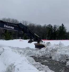 modified bulldozer blade shoveling snow